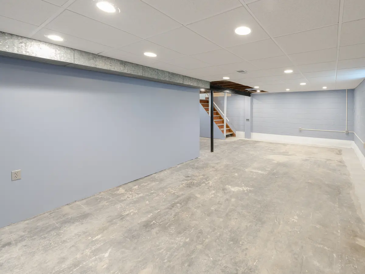 Dry basement with sound painted walls and a concrete floor