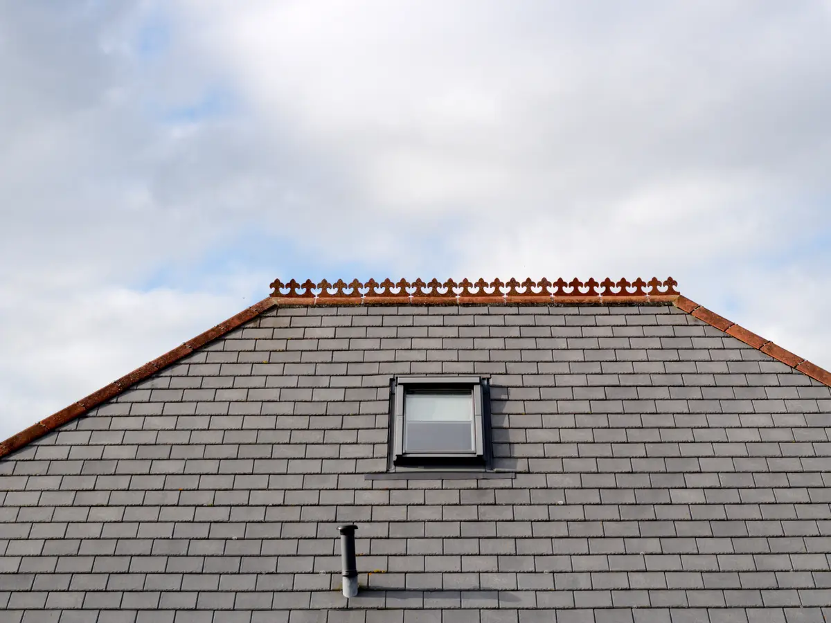 Natural slate roof with a roof window