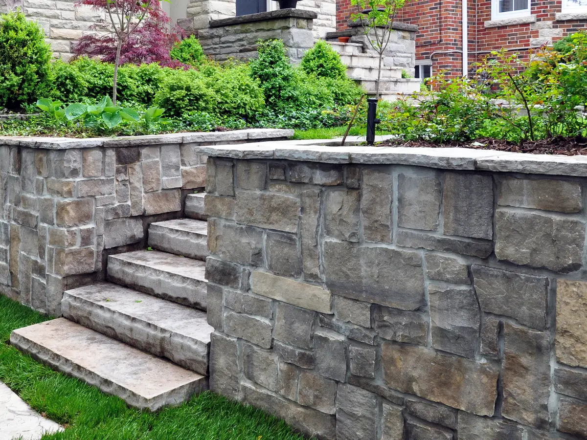 Stone retaining wall and steps in a front garden
