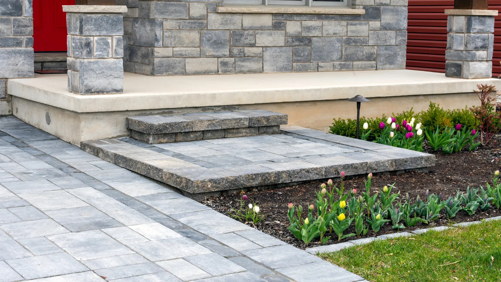 Stone front stoop and steps with a new paver walkway